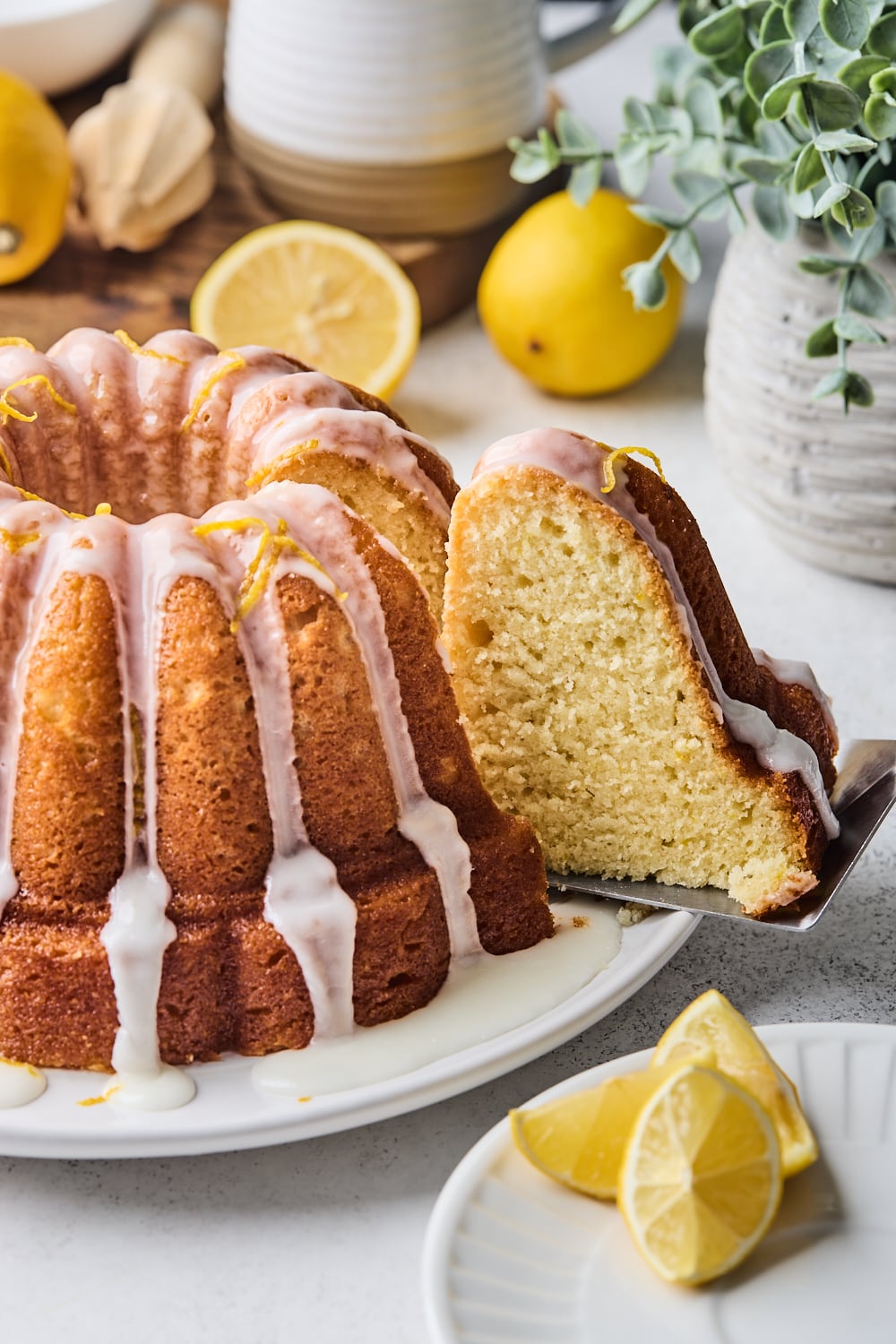 Lemon Bundt Cake with a glaze and a slice being taken out