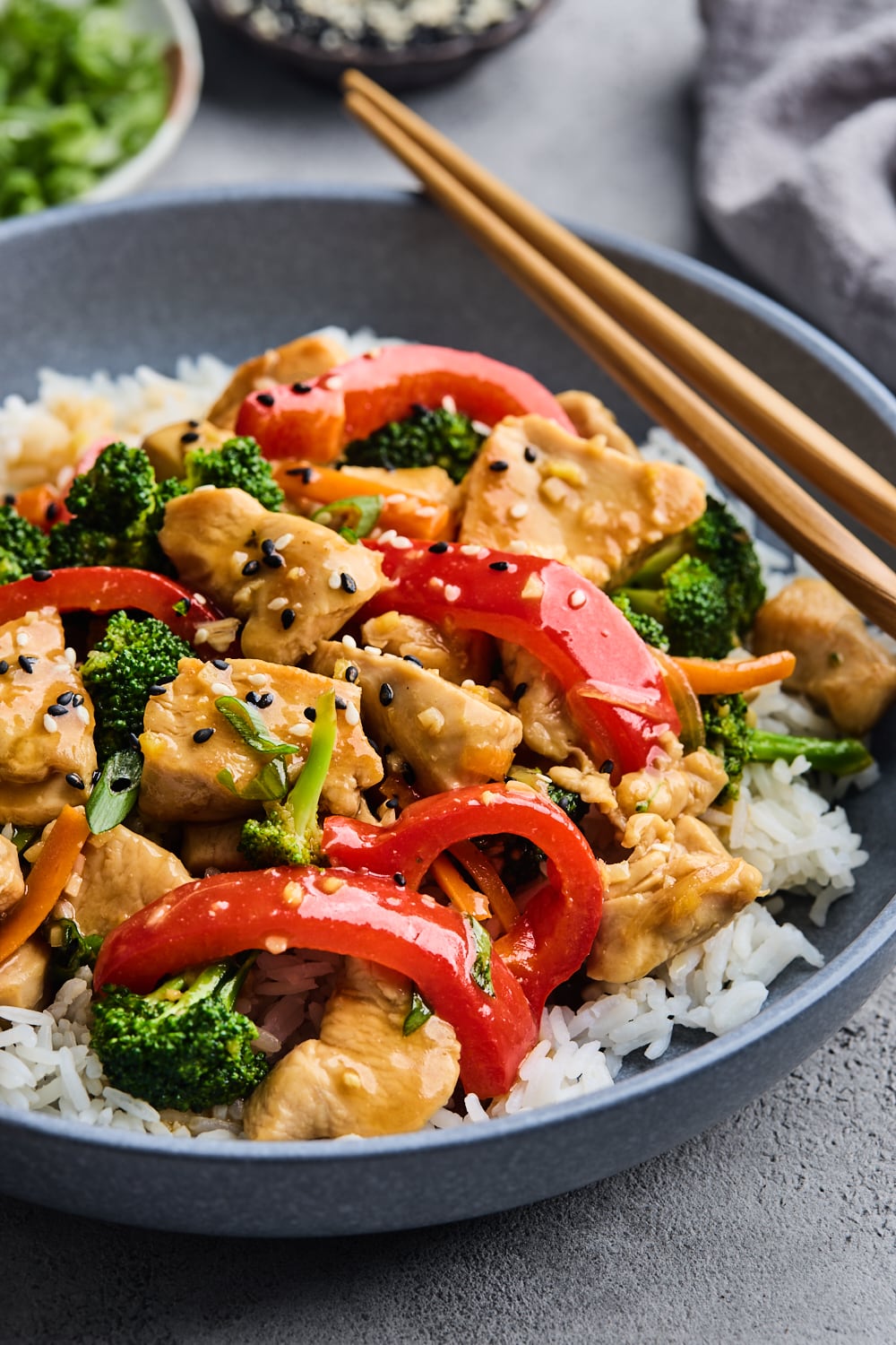 Chicken Stir Fry On A Plate With Rice Shown On An Angle