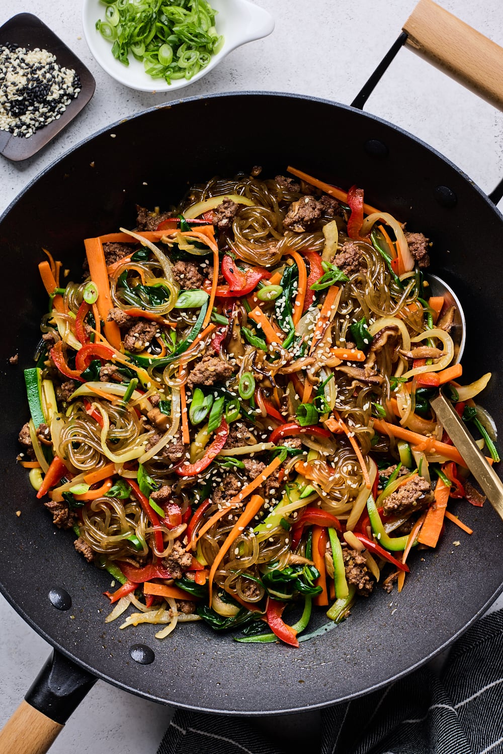 Japchae cooked in a wok